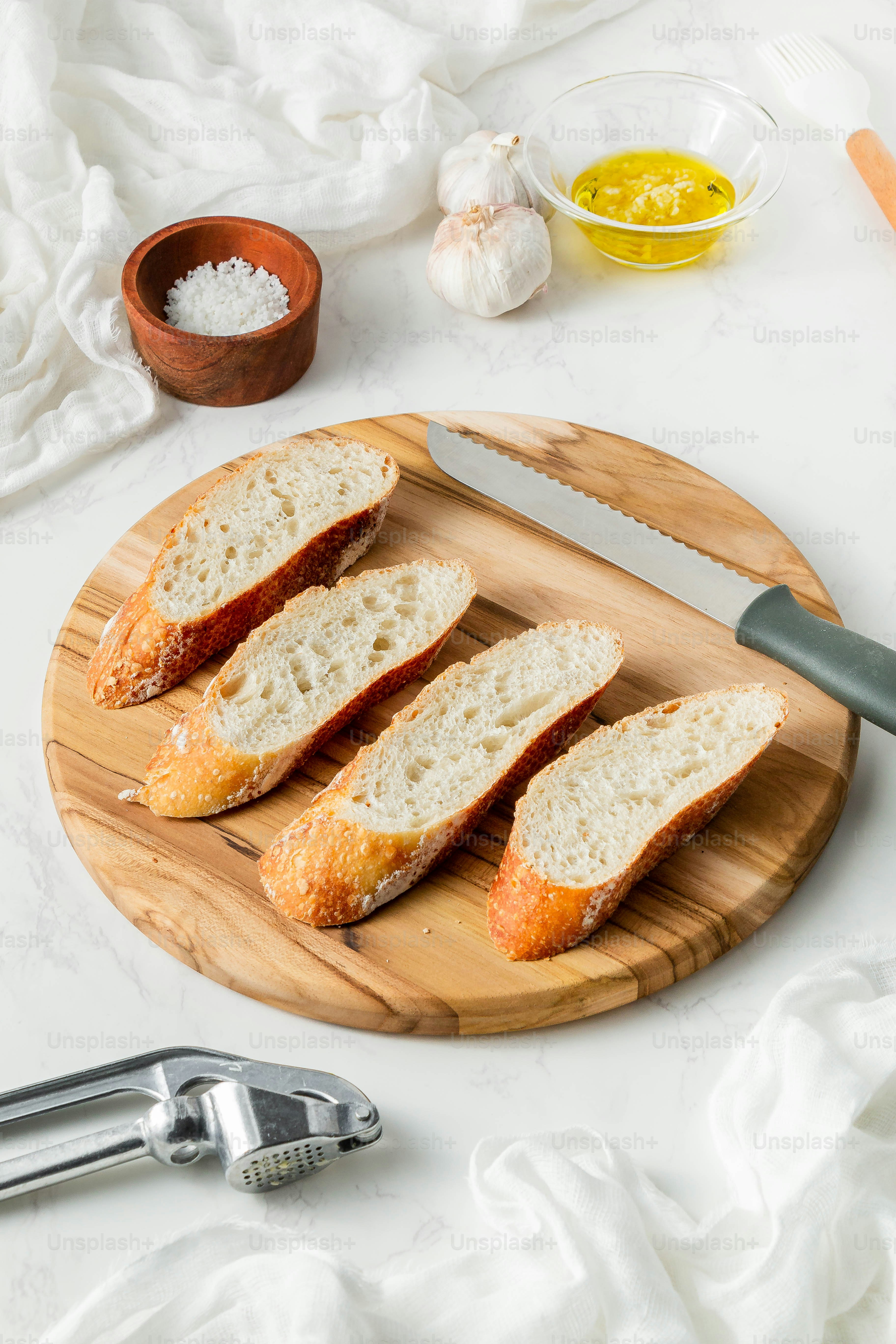 a wooden cutting board topped with slices of bread