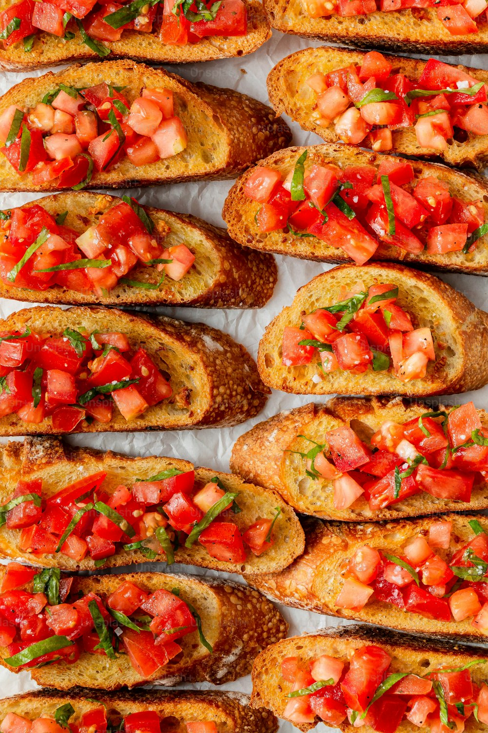 a close up of a bunch of bread with tomatoes on it