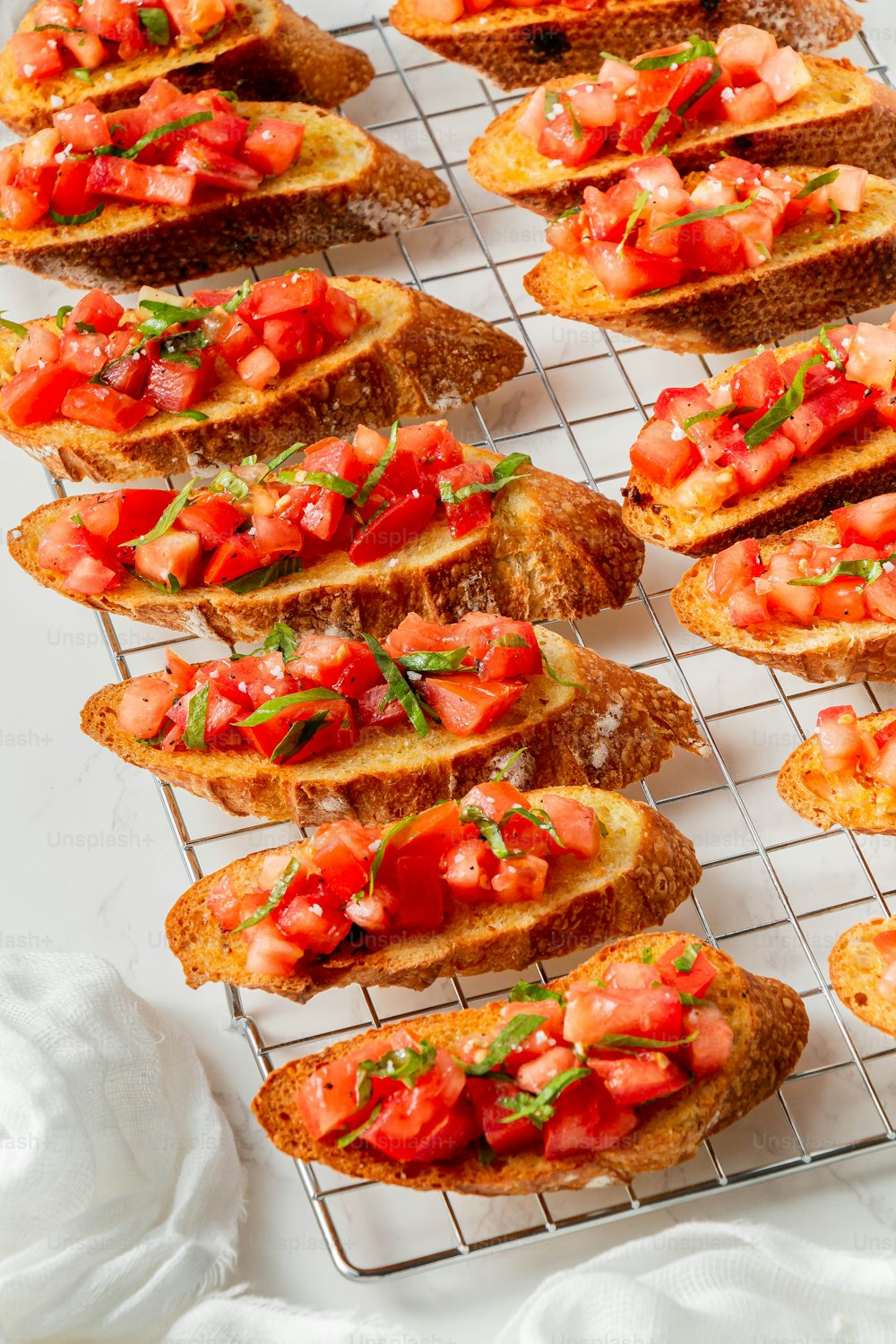 a bunch of bread with tomatoes on top of it