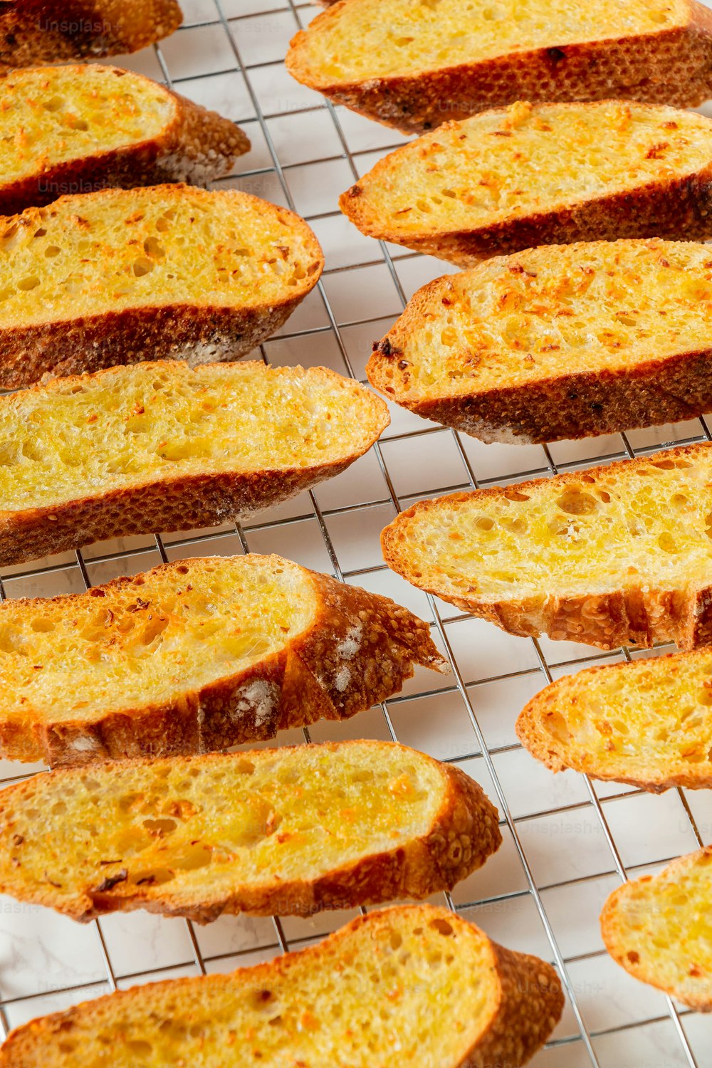 a bunch of slices of bread sitting on a rack