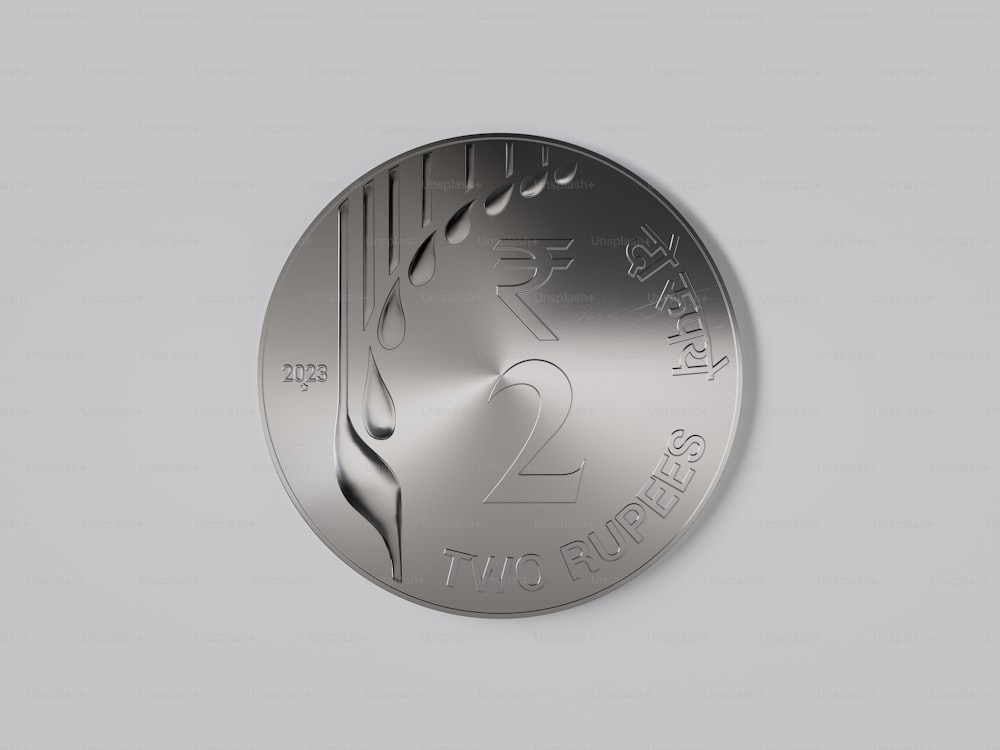 a silver medal with a design on it