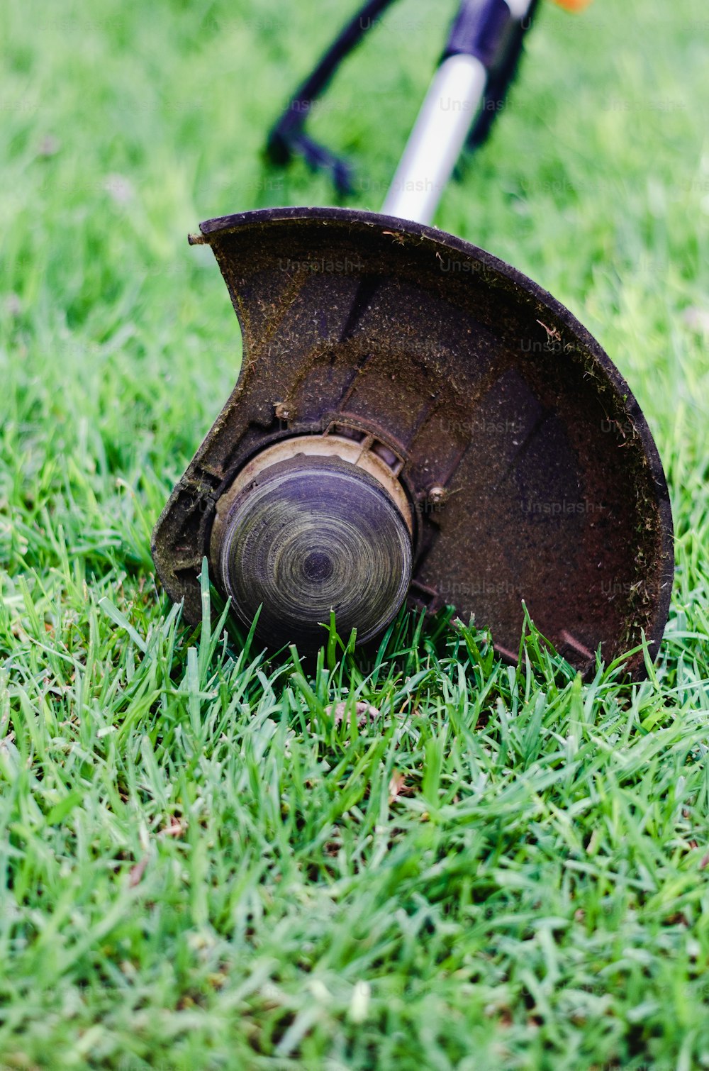 a lawn mower sitting on top of a lush green field