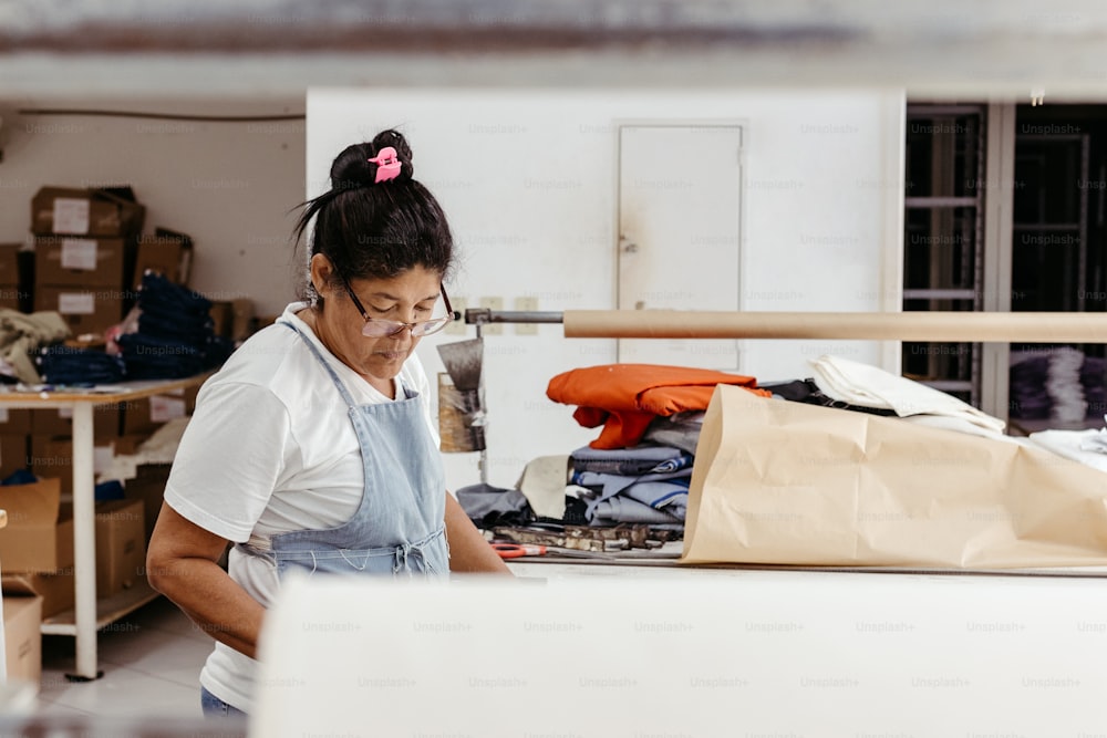 a woman is working on a piece of furniture