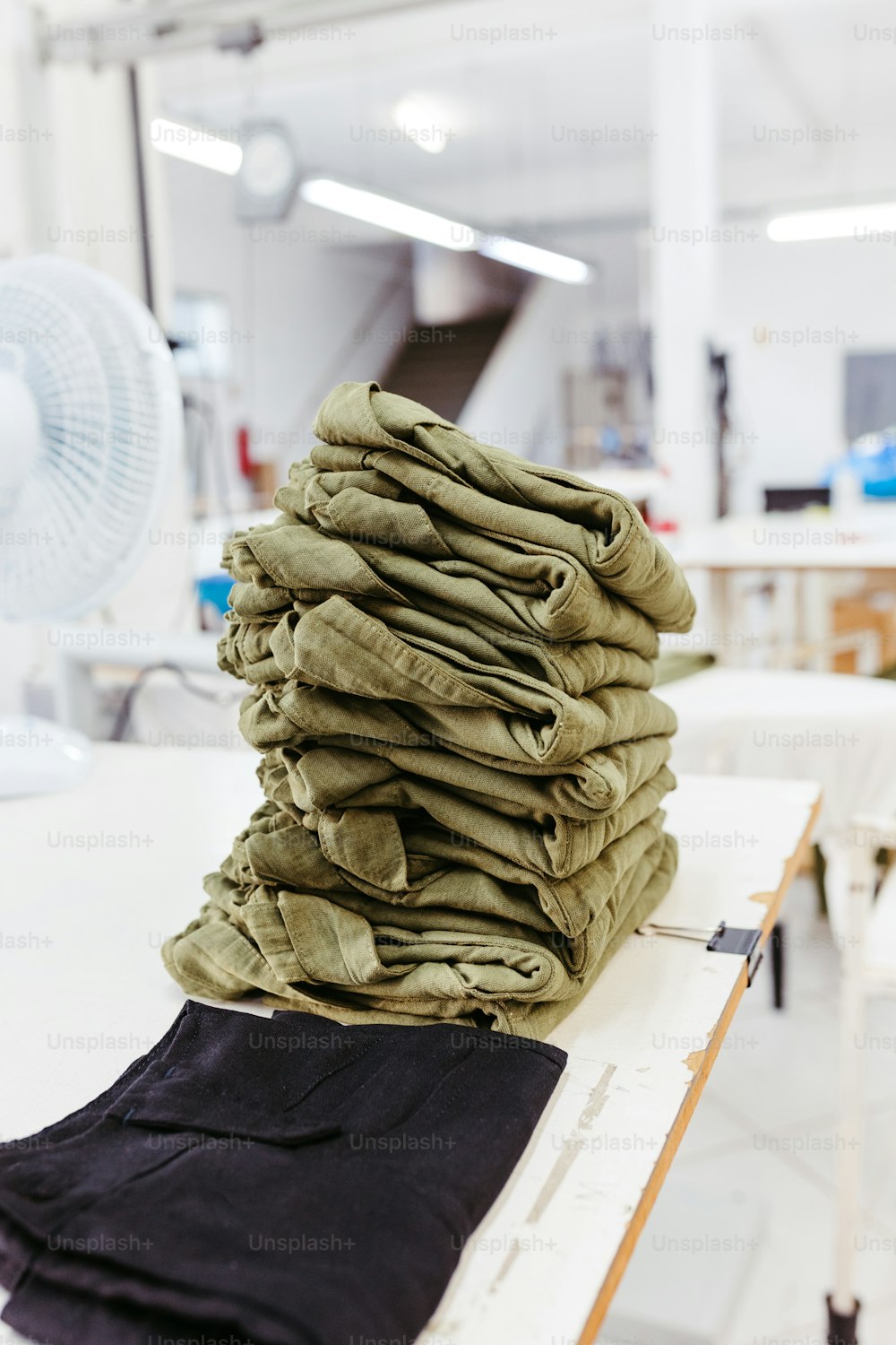 a stack of folded clothes sitting on top of a table