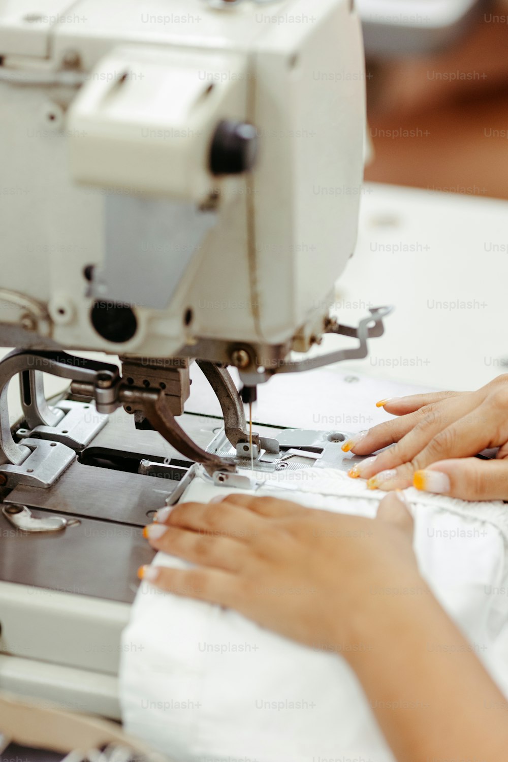 a woman is working on a sewing machine