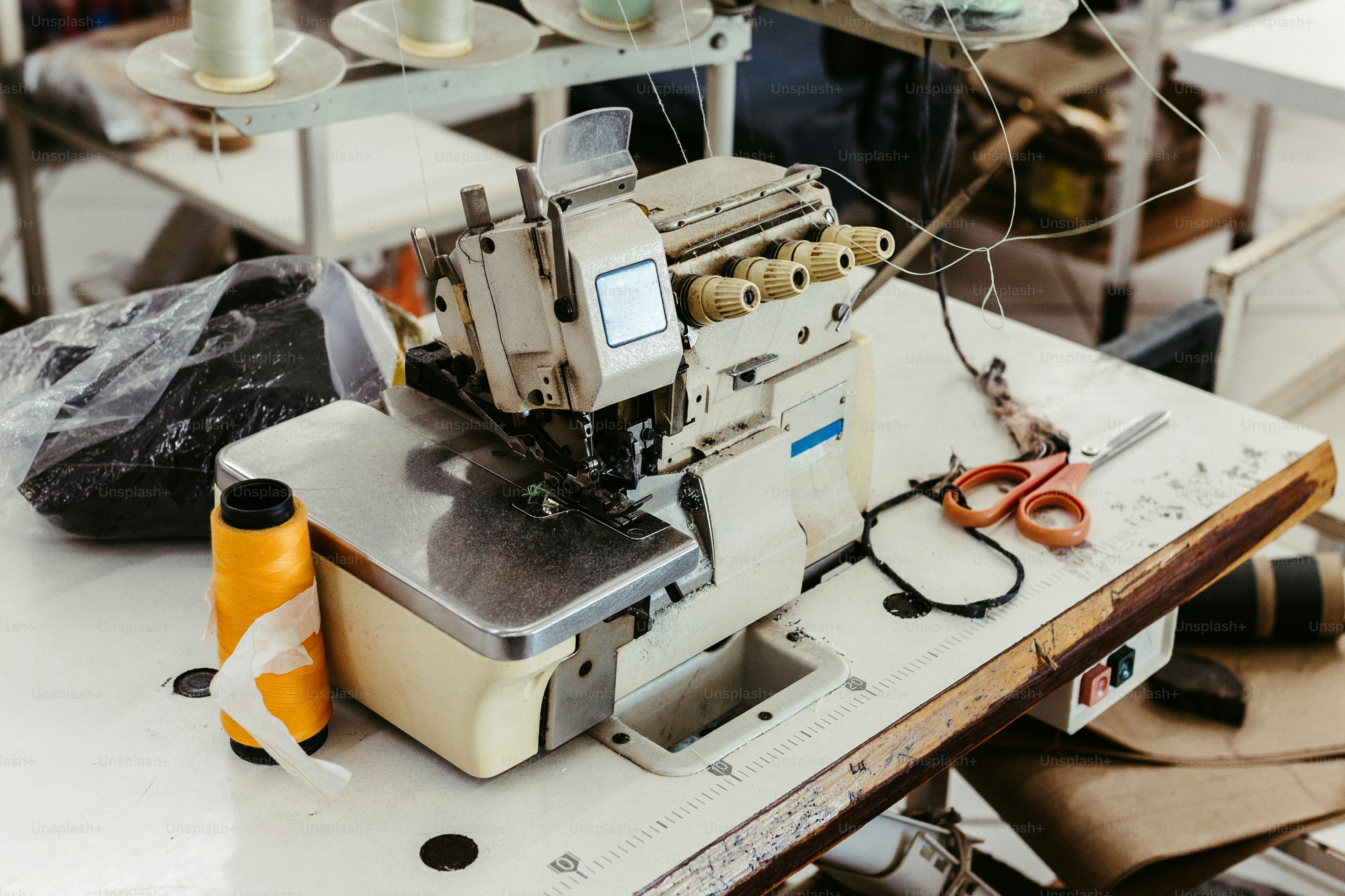 A sewing machine sitting on top of a white table photo Sewing machine