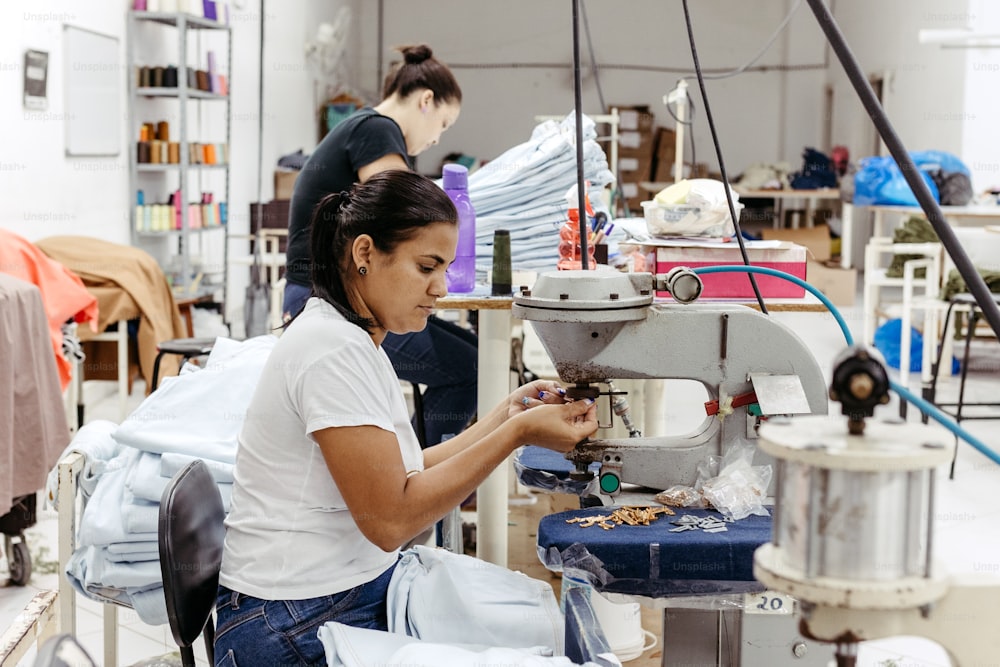 a woman working on a sewing machine in a factory