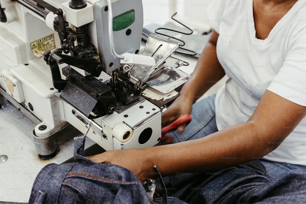 a man is working on a sewing machine
