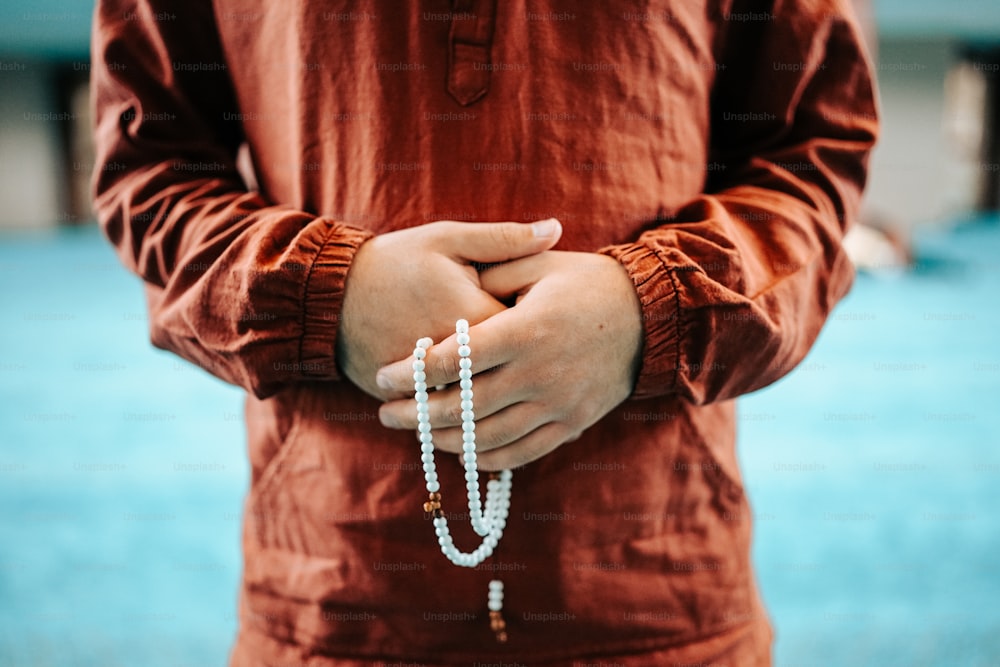 a man holding a rosary in his hands