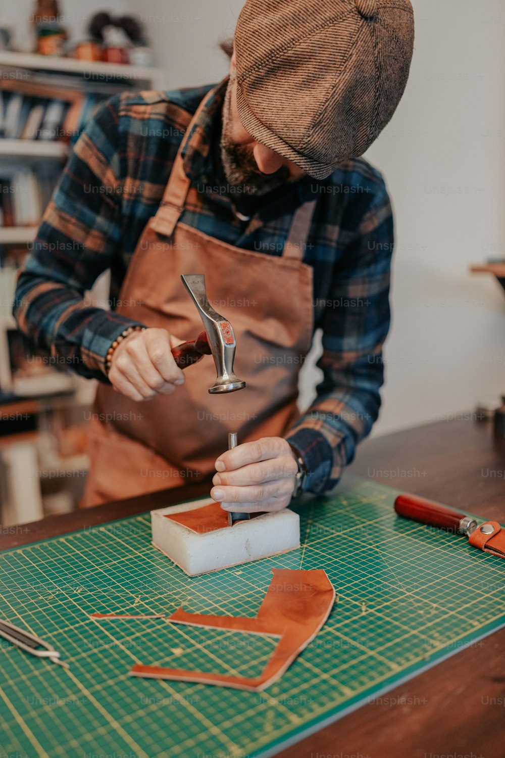 a man working on a piece of leather