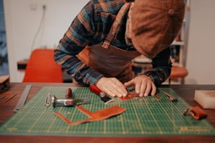 a man working on a piece of leather