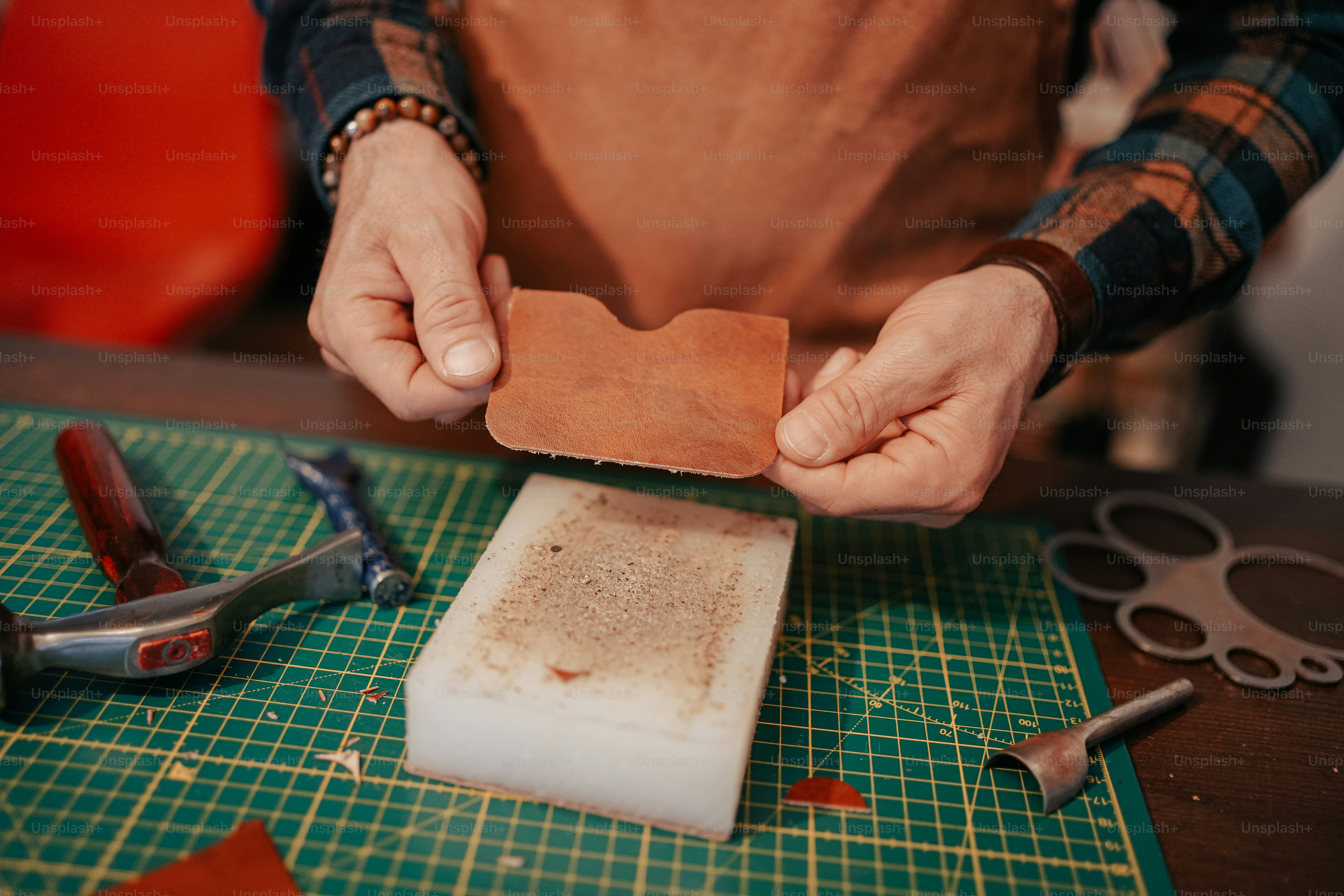 a person holding a piece of paper on top of a cutting board