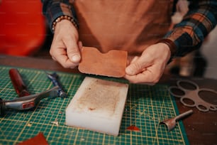 a person holding a piece of paper on top of a cutting board