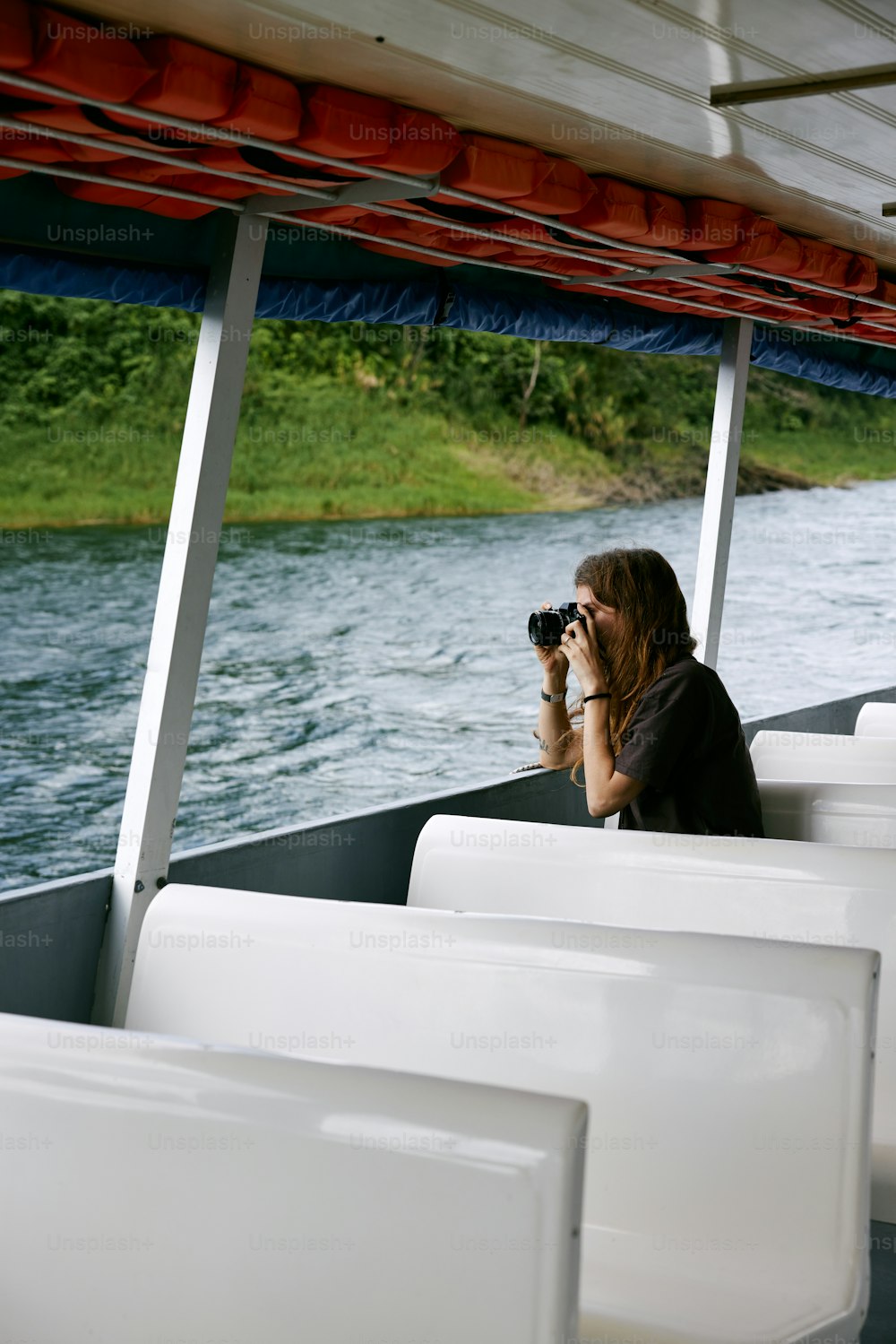 a woman taking a picture of herself on a boat