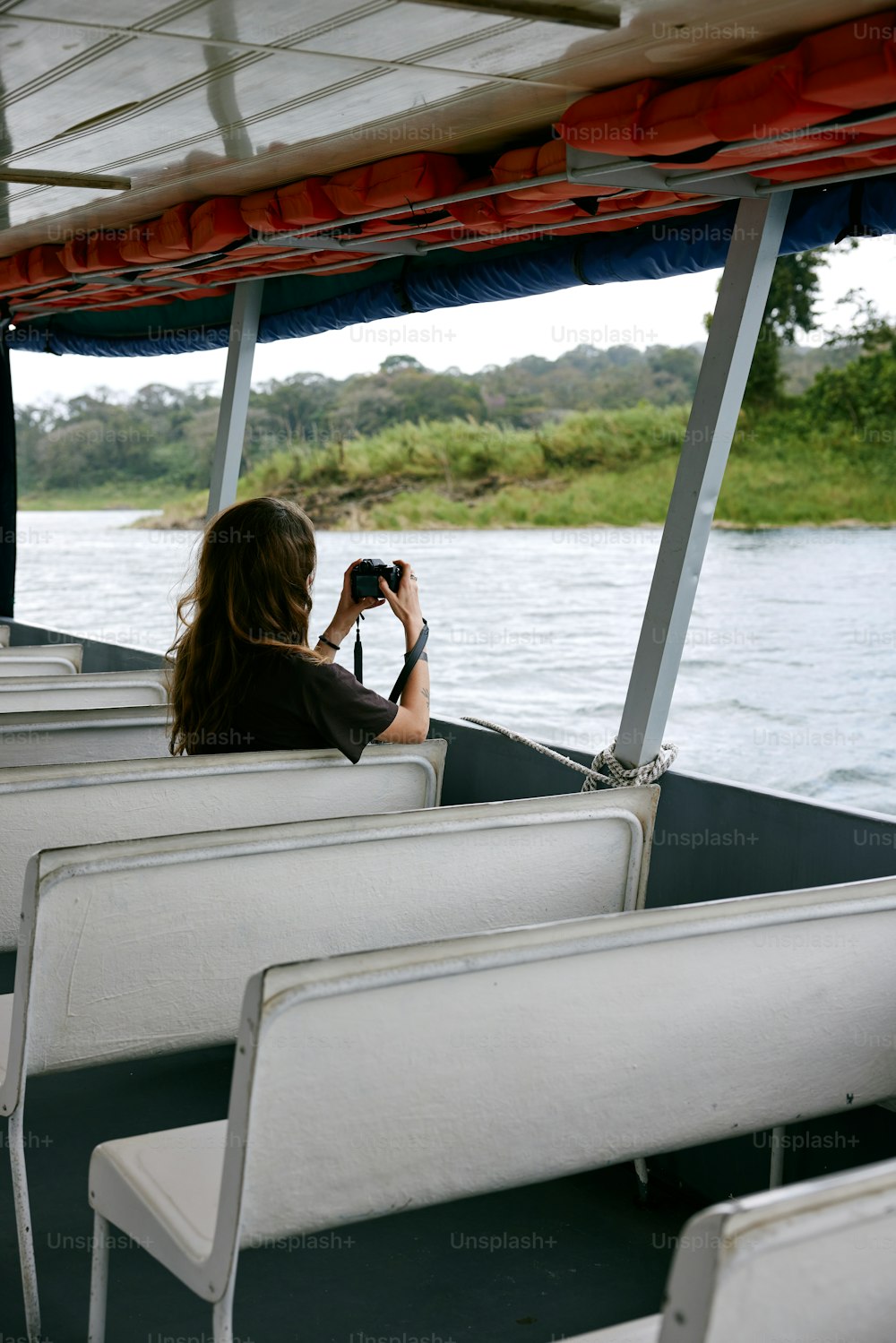 a woman taking a picture of a body of water