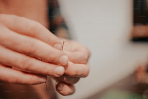 a person holding a tiny object in their hand