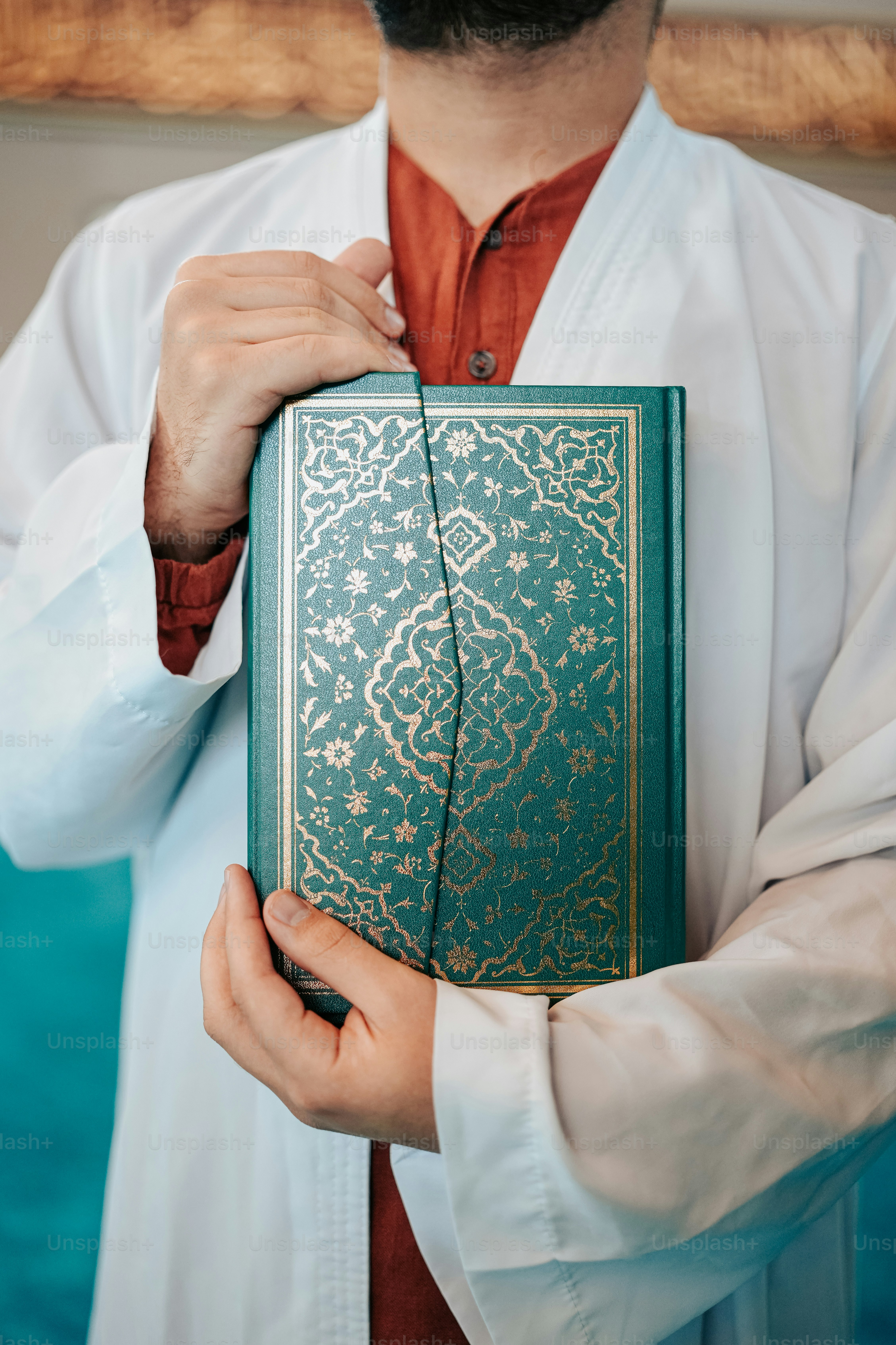 a man in a white shirt holding a green book