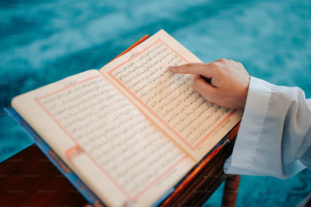 a close up of a person holding a book