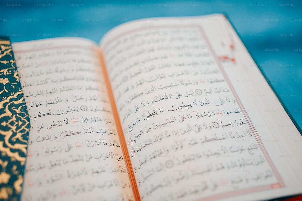 a close up of an open book with arabic writing