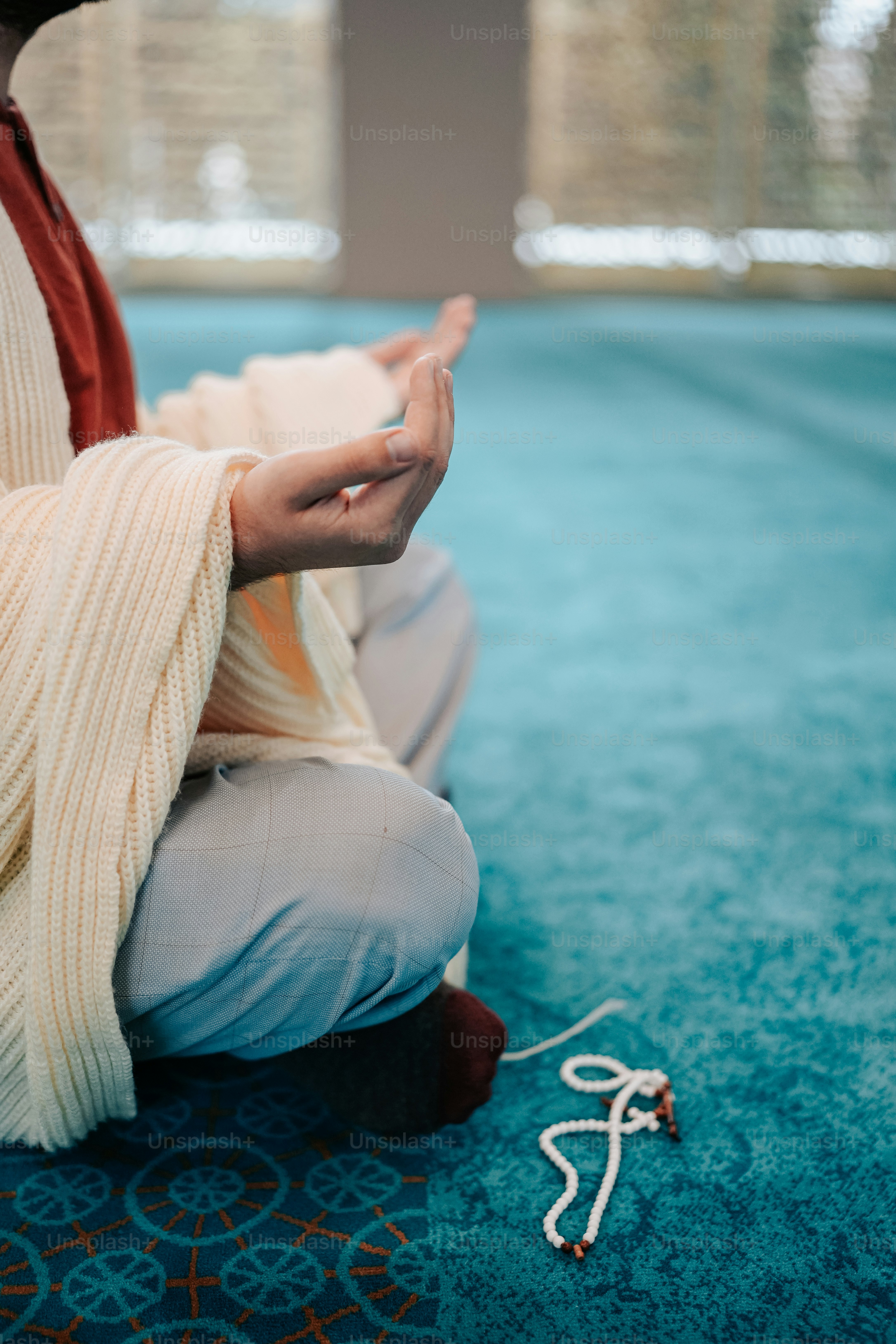 a woman sitting on the floor with her hands in the air