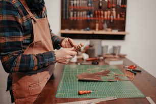 a man is working on a piece of leather