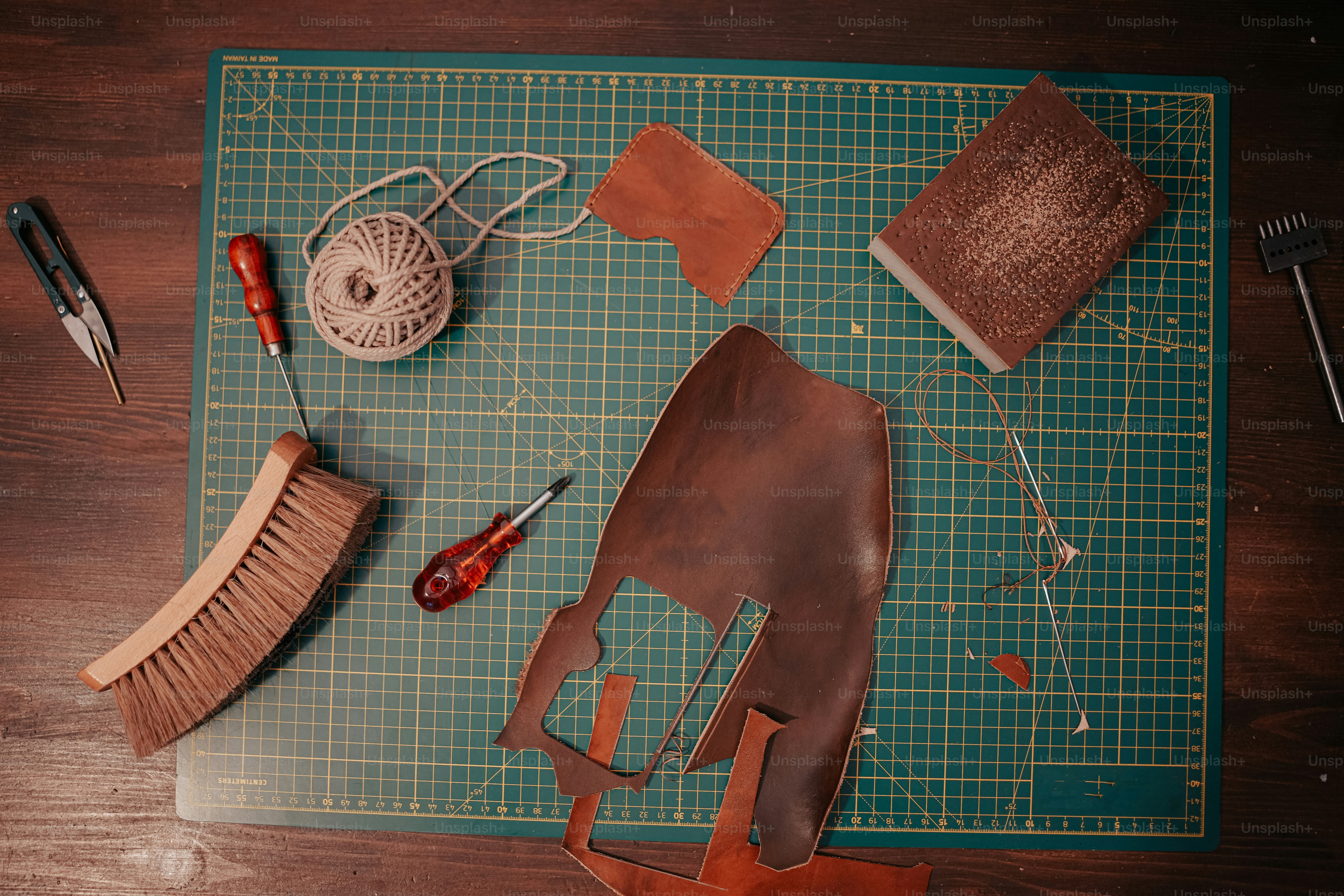 a green cutting board topped with lots of crafting supplies