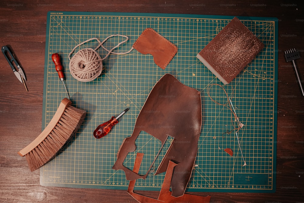 a green cutting board topped with lots of crafting supplies