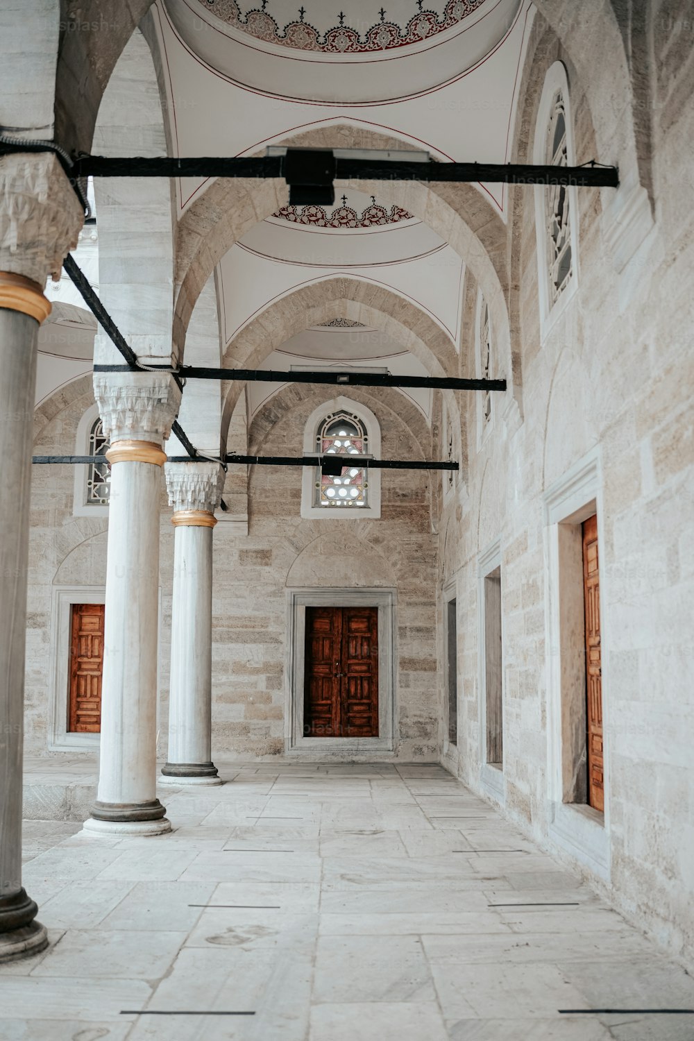 a large room with columns and a door