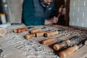 a man is working on a carving project