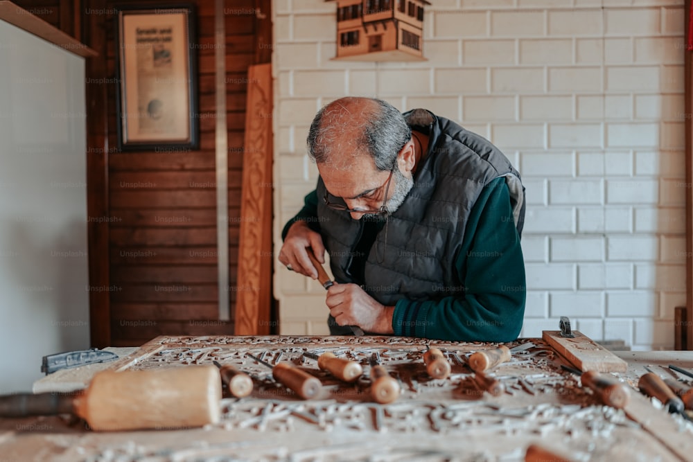 a man is working on a piece of wood