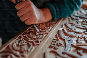 a close up of a person carving a piece of wood