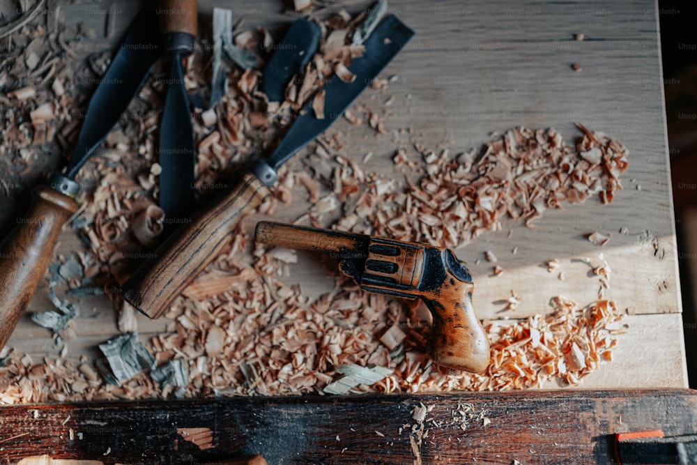 a hammer and some wood shavings on a table