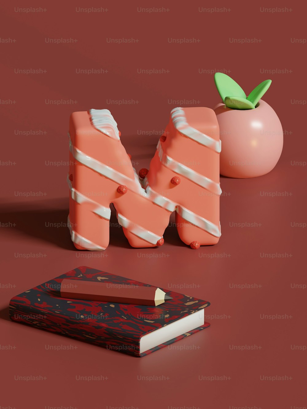un livre, un crayon et une pomme sur une table