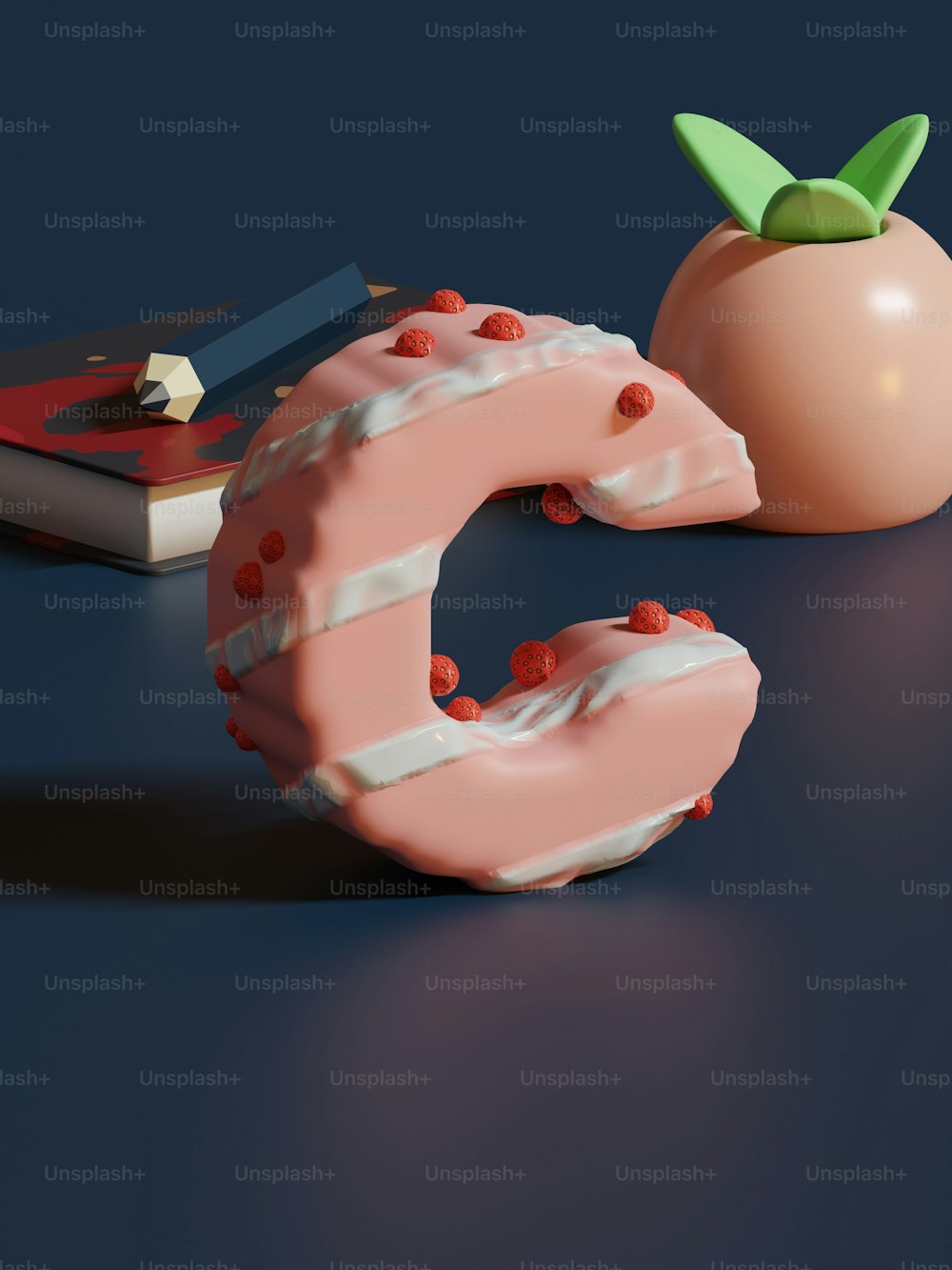 a donut with a green leaf on top of it next to a book and