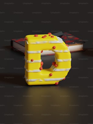 a yellow and white plastic letter sitting on top of a table