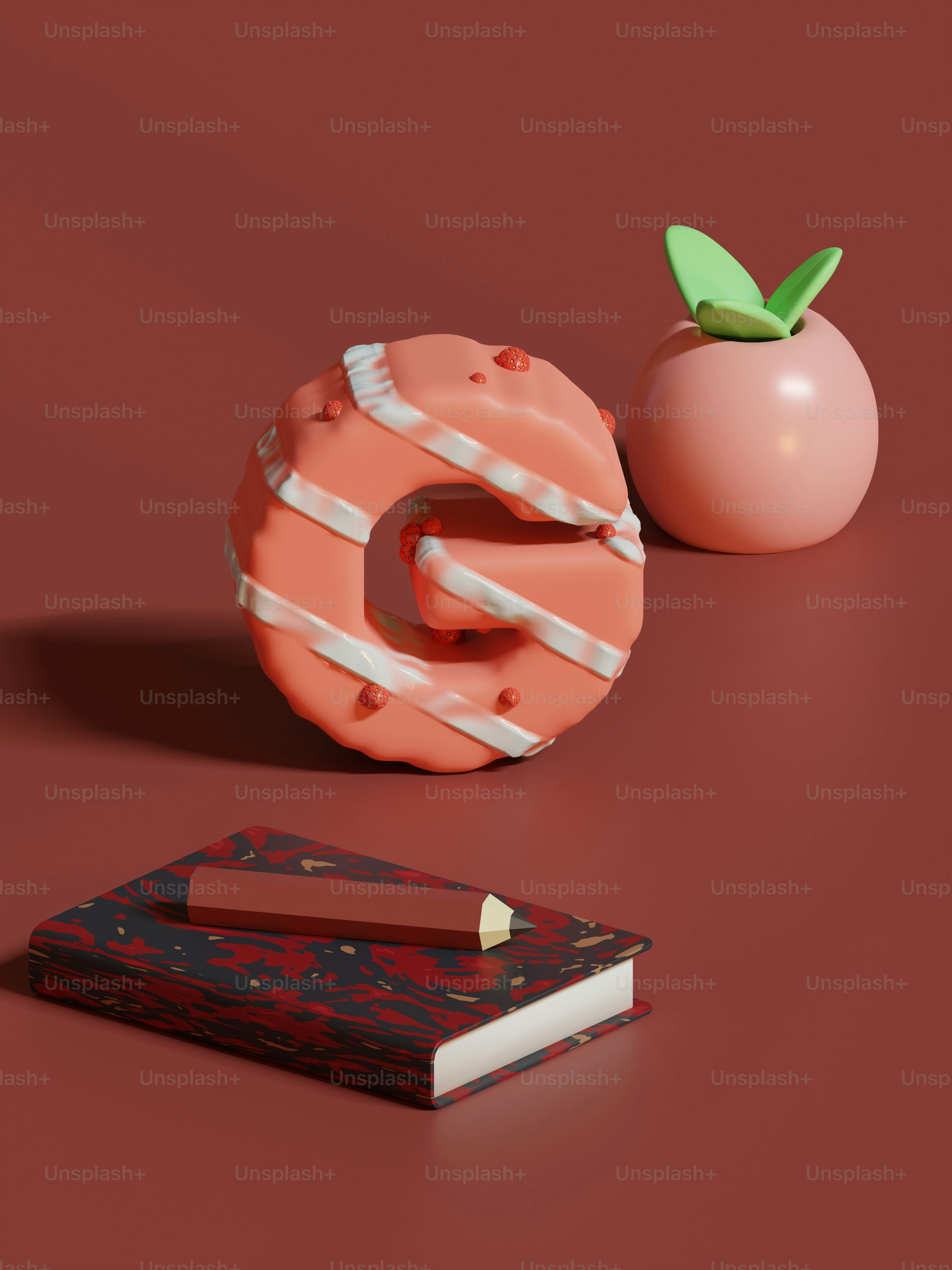 Un beignet et un livre sur une surface rouge