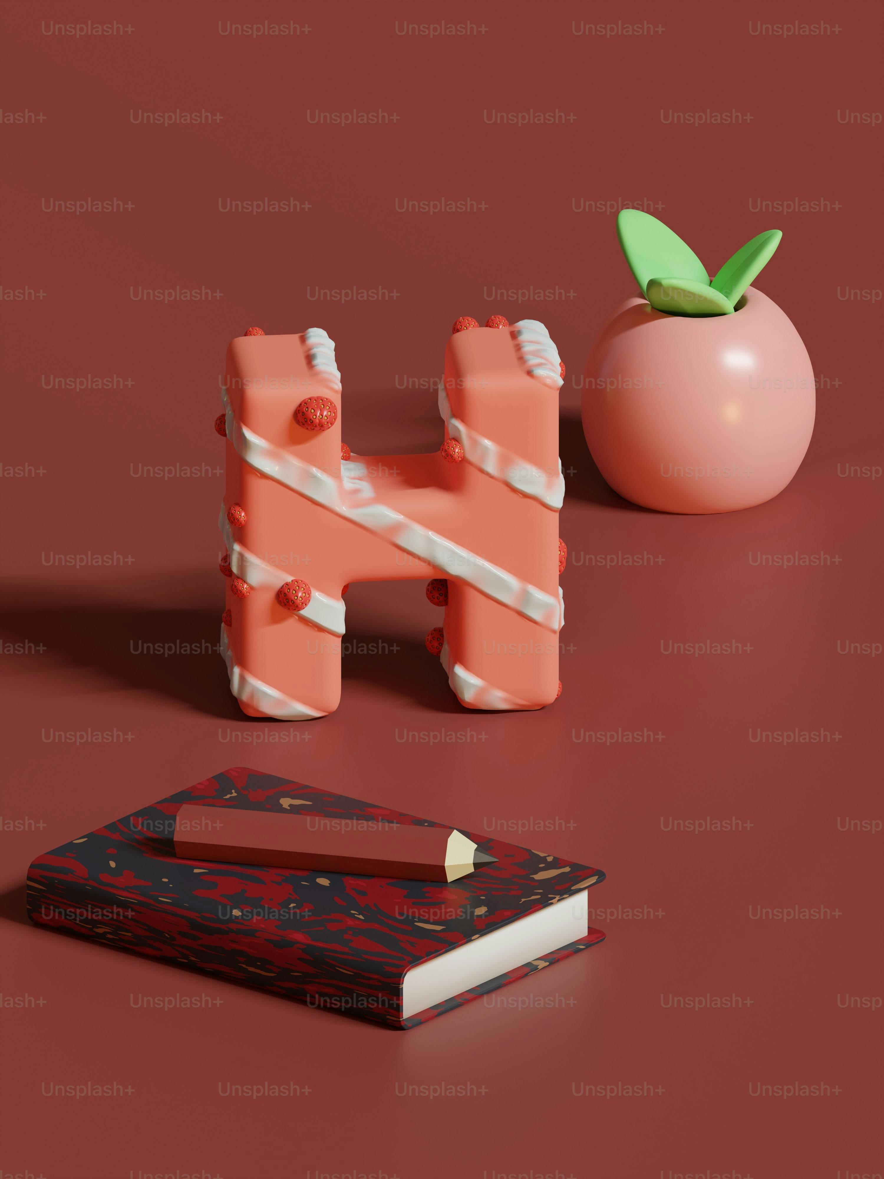 Ein rosa Objekt, das auf einem Tisch neben einem Buch sitzt