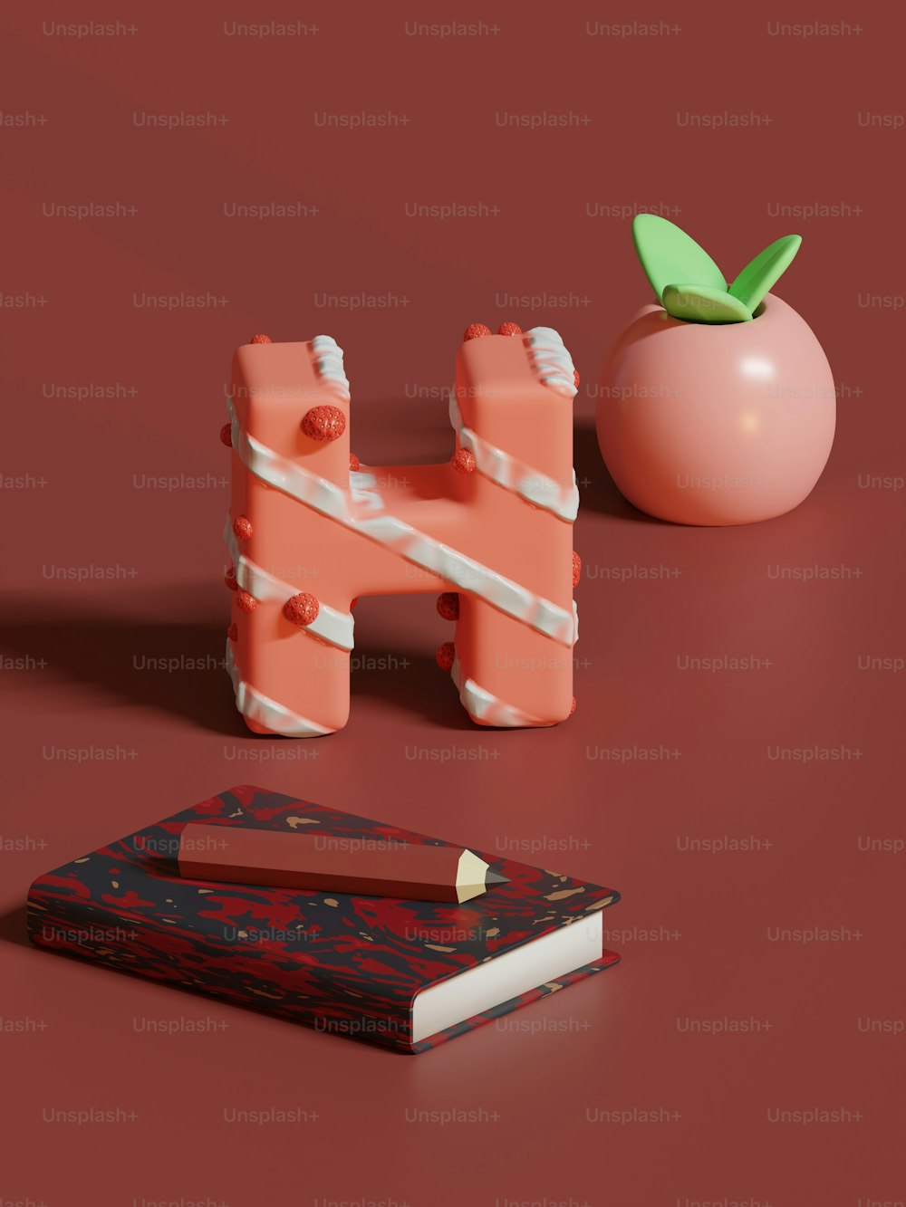 Un objeto rosa sentado encima de una mesa junto a un libro