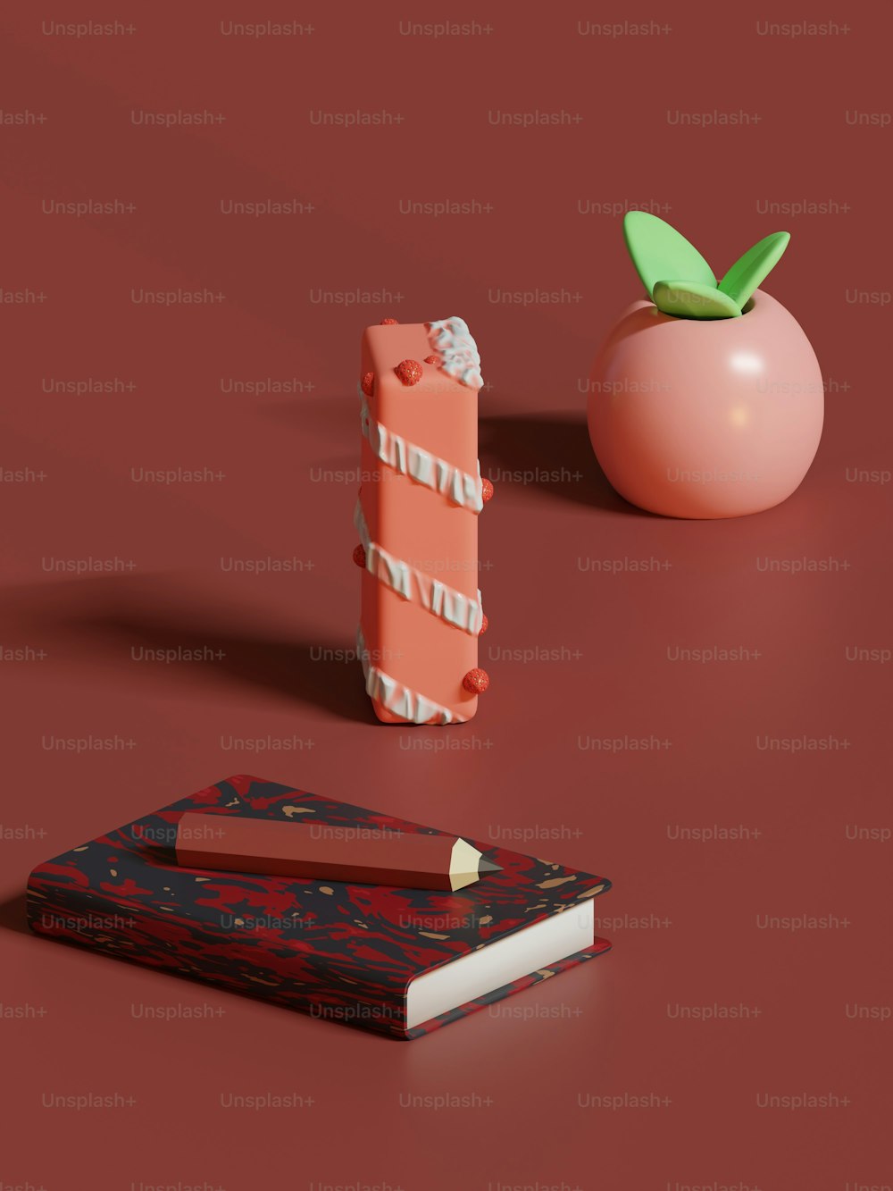 um tomate e um livro em uma superfície vermelha
