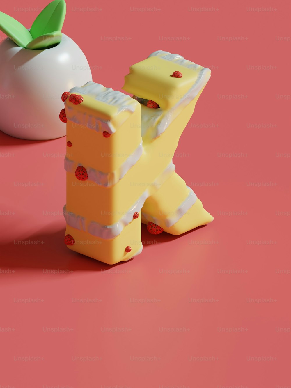 um pedaço de queijo sentado ao lado de uma maçã em uma superfície rosa