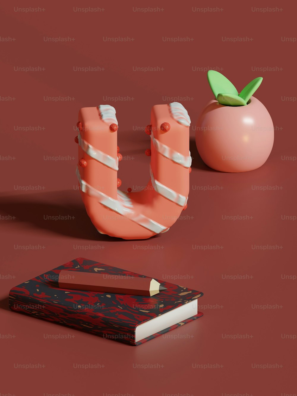 ein Buch, eine Tomate und eine Schere auf einer roten Oberfläche