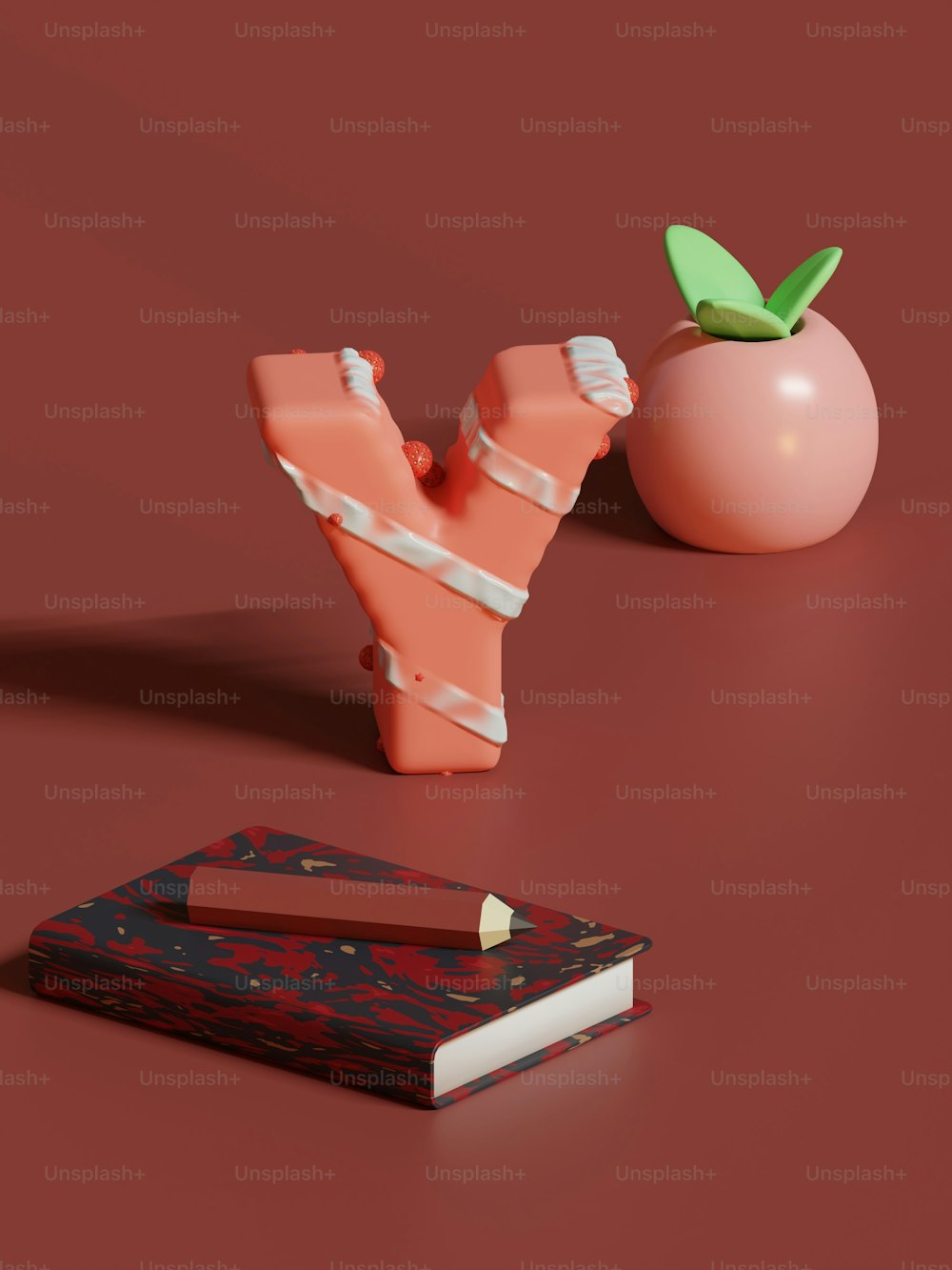 a piece of paper next to an apple and a book