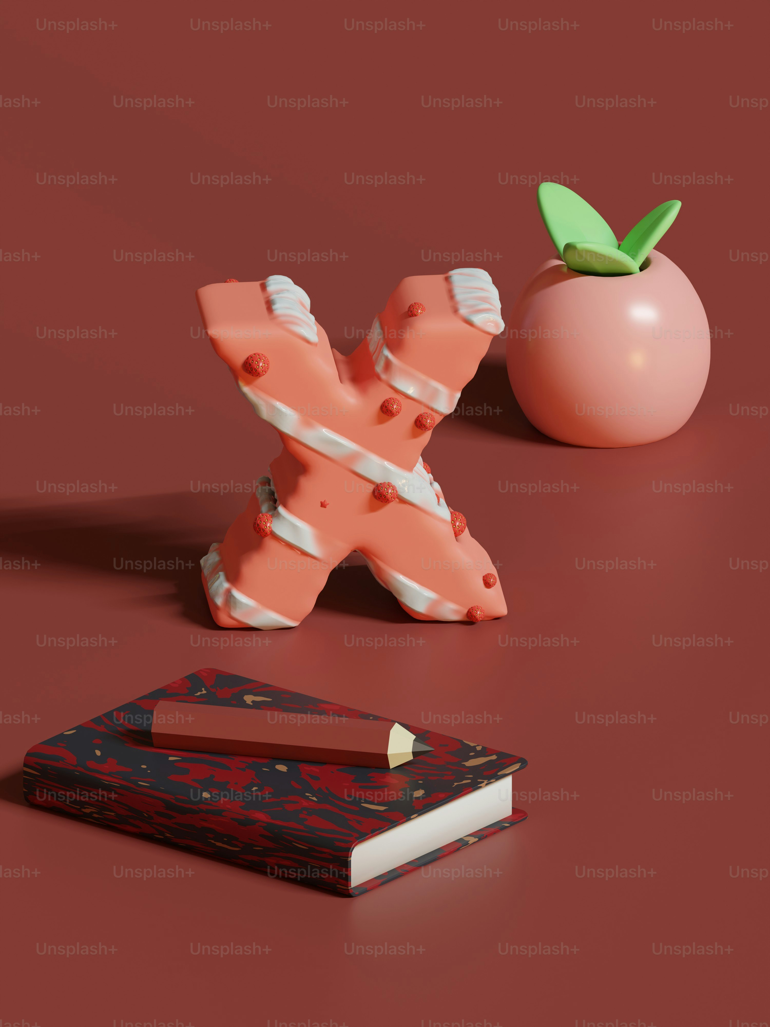 a book, pencil, and apple on a red surface