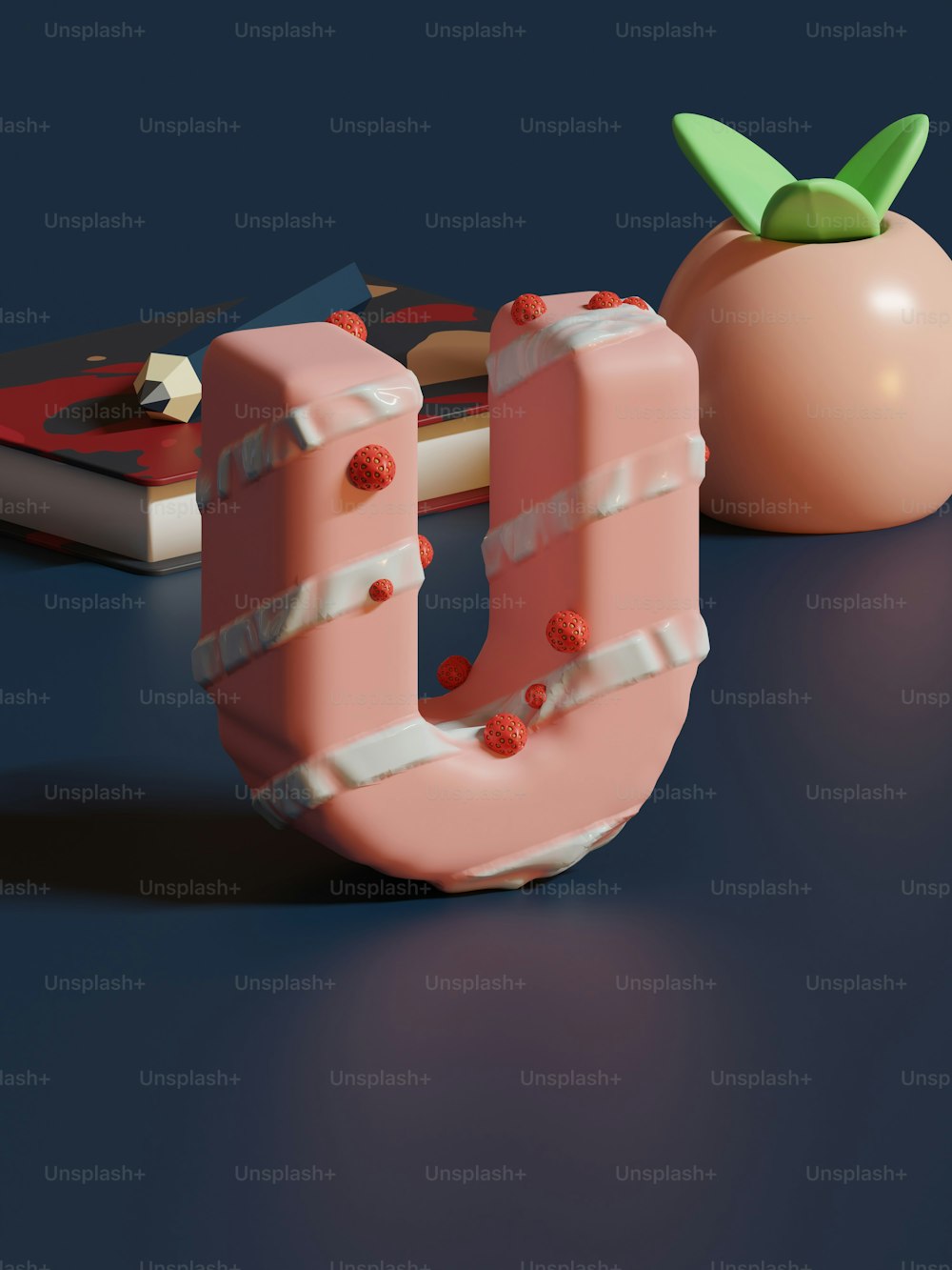 Ein 3D-Bild des Buchstabens U neben einem Apfel