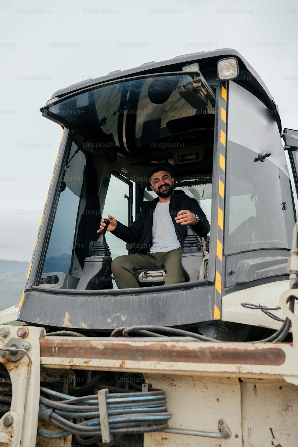 a man sitting in the driver's seat of a truck