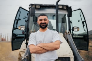 a man standing in front of a tractor