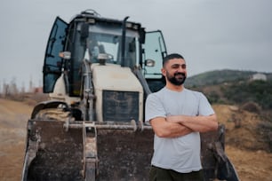 a man standing in front of a bulldozer