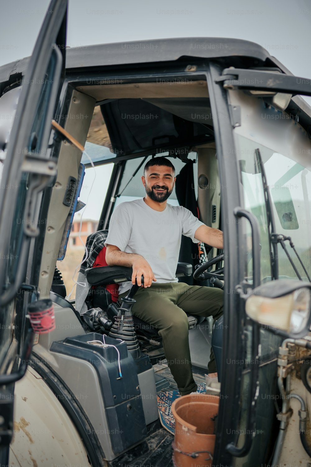 a man sitting in the driver's seat of a vehicle