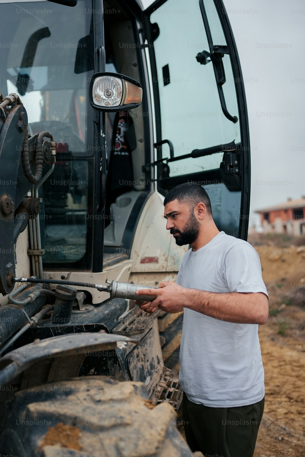 a man standing in front of a tractor