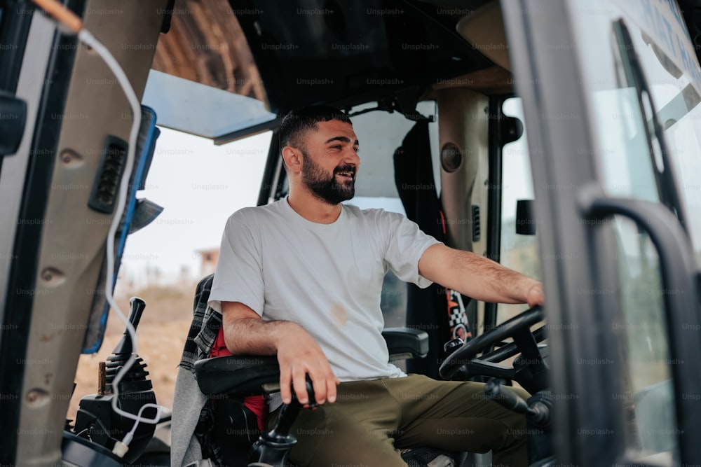 a man sitting in the driver's seat of a tractor